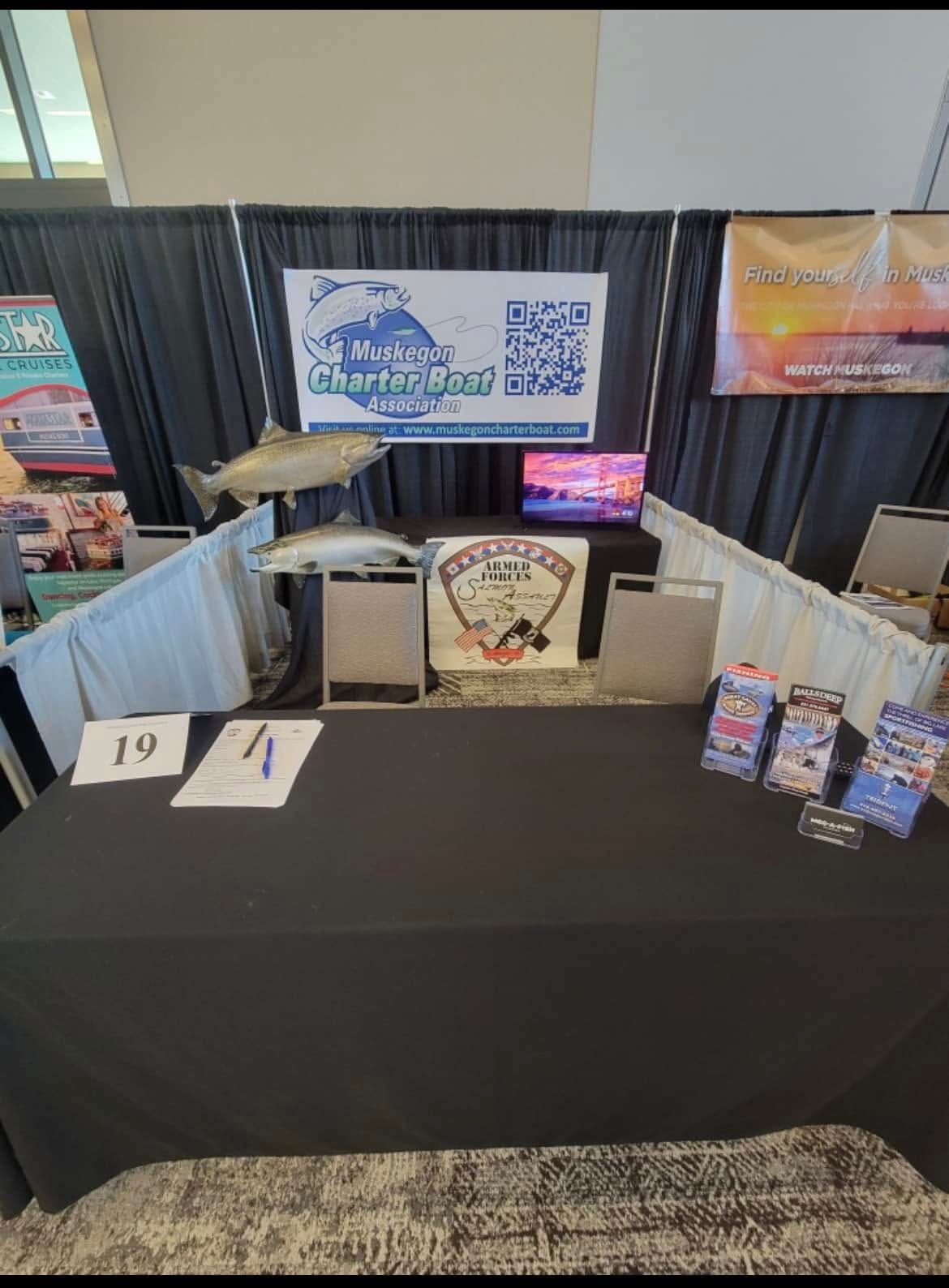 The association's event booth with mounted fish, signage and informational materials